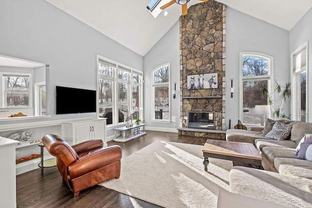living room with plenty of natural light, ceiling fan, a fireplace, and wood finished floors