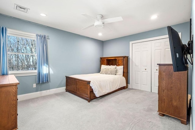 bedroom featuring carpet floors, a closet, visible vents, and baseboards