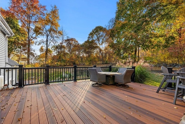 deck with outdoor dining area and fence