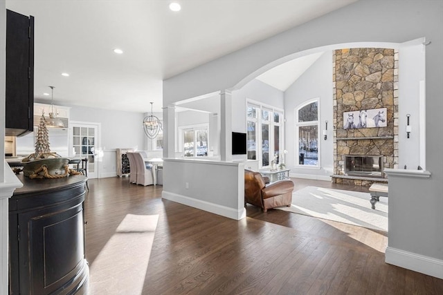 living room with plenty of natural light, a fireplace, and wood finished floors