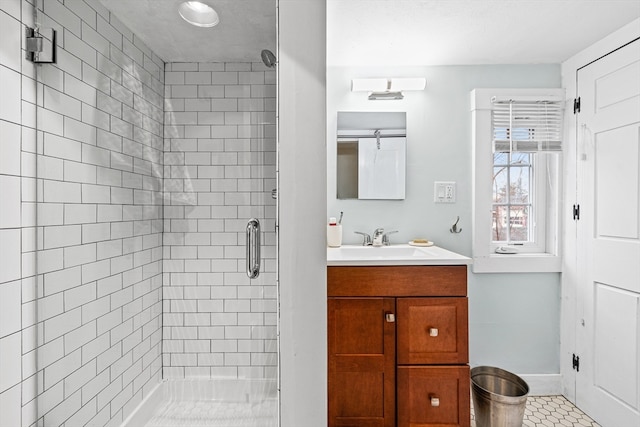 bathroom with tile patterned flooring, vanity, and a shower with shower door