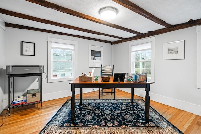 office with hardwood / wood-style flooring, beamed ceiling, and a textured ceiling