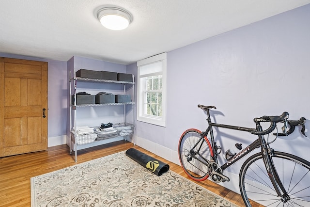 bedroom featuring hardwood / wood-style floors and a textured ceiling