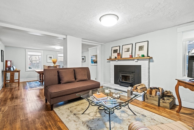 living room featuring hardwood / wood-style floors and a textured ceiling