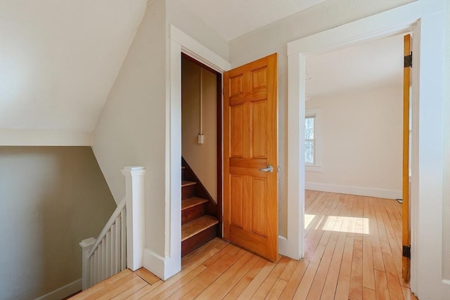 staircase with wood-type flooring and baseboards