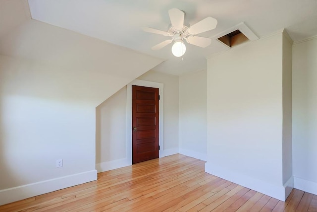additional living space featuring light wood-type flooring, baseboards, and a ceiling fan