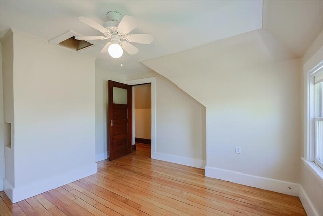 bonus room featuring light wood finished floors, baseboards, a ceiling fan, and healthy amount of natural light