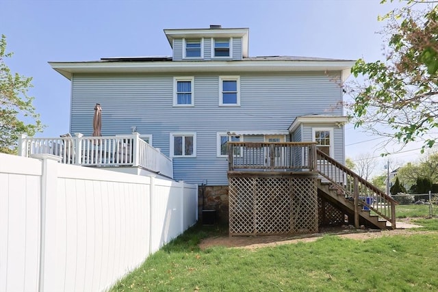 rear view of house featuring stairs and a wooden deck