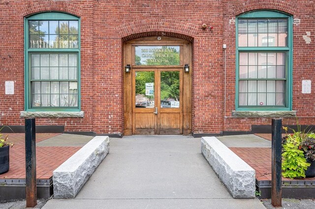 property entrance featuring brick siding