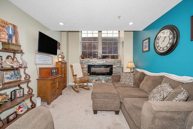 living room with recessed lighting, light carpet, a textured ceiling, and a fireplace