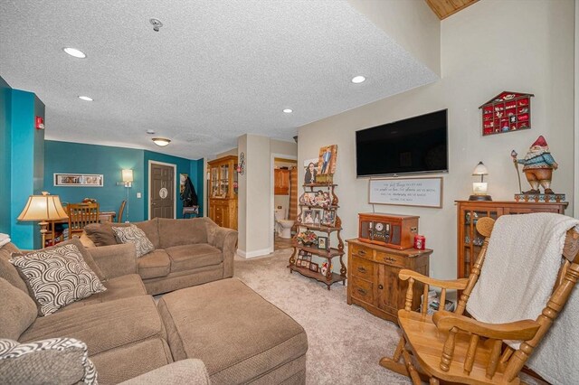 carpeted living room featuring recessed lighting and a textured ceiling