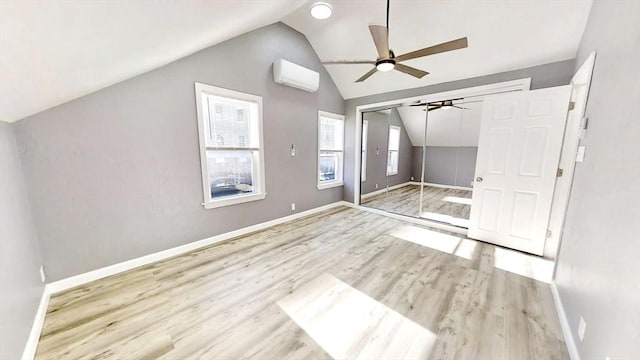 55 Mendon St, Worcester, MA 01604 - unfurnished bedroom featuring vaulted ceiling, a wall unit AC, wood finished floors, baseboards, and ceiling fan