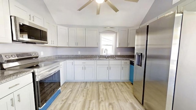 55 Mendon St, Worcester, MA 01604 - kitchen with stainless steel appliances, vaulted ceiling, a sink, a ceiling fan, and light wood-style flooring