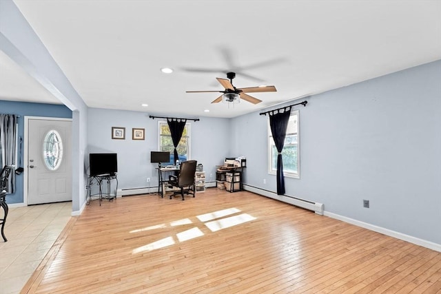 living area with baseboard heating, ceiling fan, an office area, light wood-type flooring, and recessed lighting