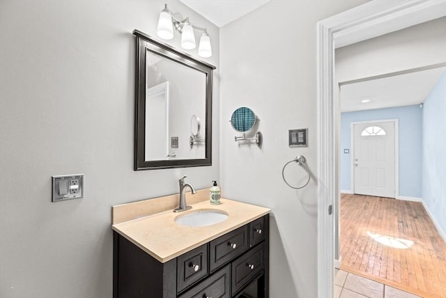 bathroom with vanity, baseboards, and wood finished floors