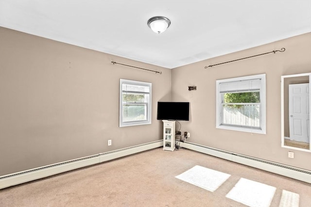 carpeted spare room featuring a baseboard heating unit