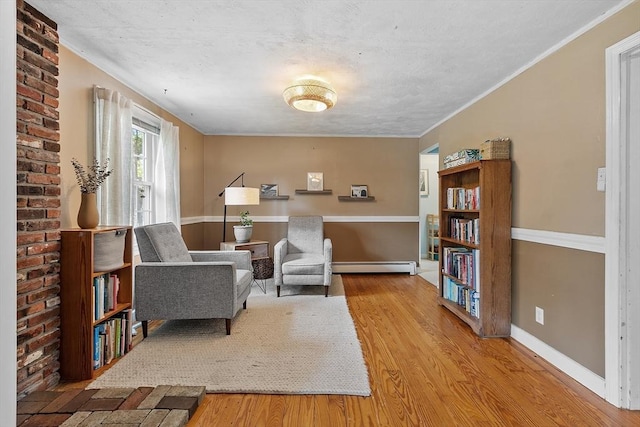 7 Squannacook Ter, Townsend, MA 01469 - sitting room with a baseboard heating unit, wood finished floors, and baseboards