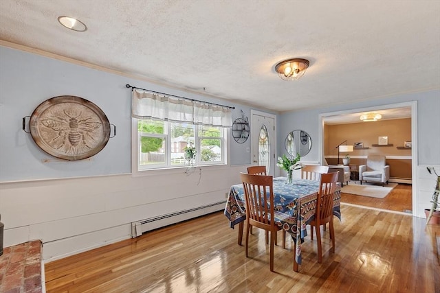 7 Squannacook Ter, Townsend, MA 01469 - dining room with baseboard heating, wood finished floors, and a textured ceiling