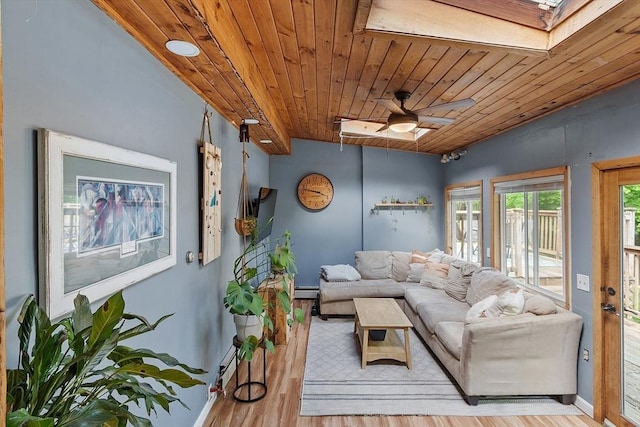 7 Squannacook Ter, Townsend, MA 01469 - living room featuring a skylight, a baseboard heating unit, light wood-style floors, wooden ceiling, and baseboards