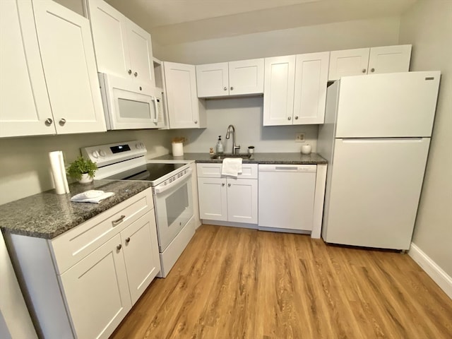 kitchen featuring white cabinetry, sink, white appliances, and light wood-type flooring