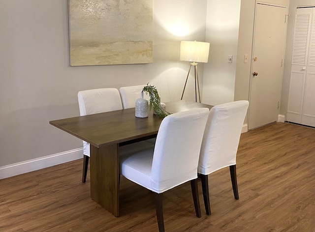 dining room with dark hardwood / wood-style flooring