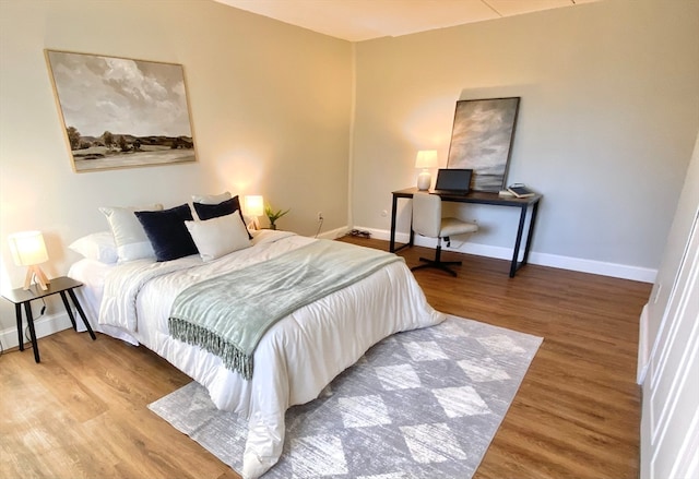 bedroom with hardwood / wood-style flooring