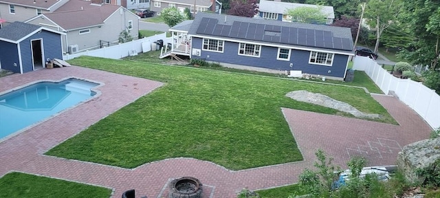 view of swimming pool with a fenced in pool, a residential view, a fenced backyard, and a lawn