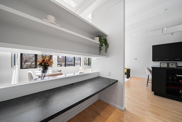 interior space featuring baseboards and light wood-style floors