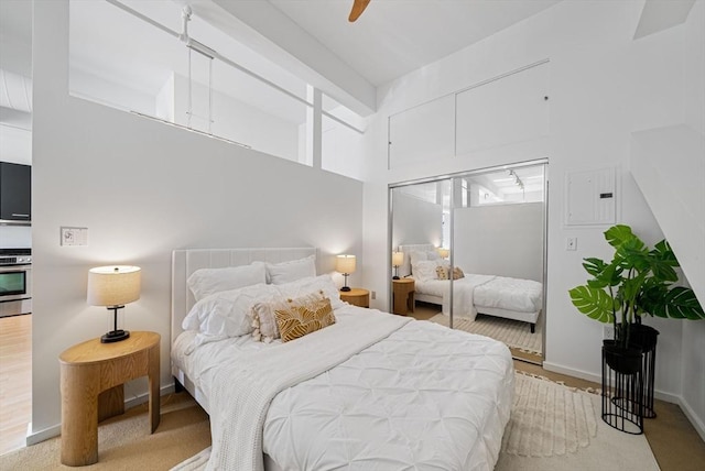 bedroom with baseboards, a closet, and ceiling fan