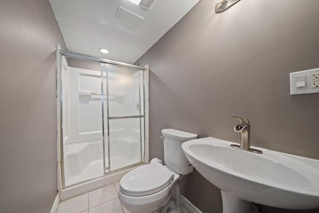 bathroom with toilet, sink, a shower with shower door, and tile patterned flooring