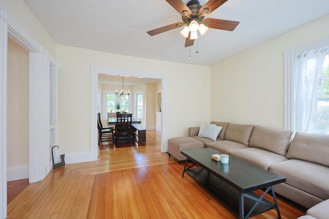 6 Minerva St, Swampscott, MA 01907 - living room featuring a chandelier, light wood-style flooring, ceiling fan, and baseboards