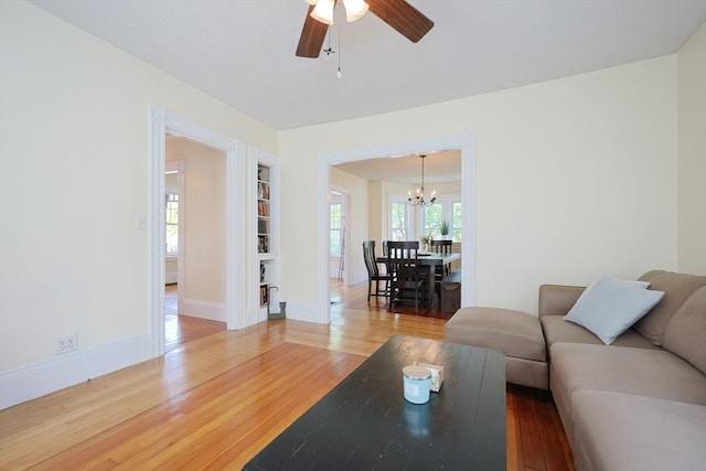 6 Minerva St, Swampscott, MA 01907 - living room with a chandelier, wood finished floors, ceiling fan, and baseboards