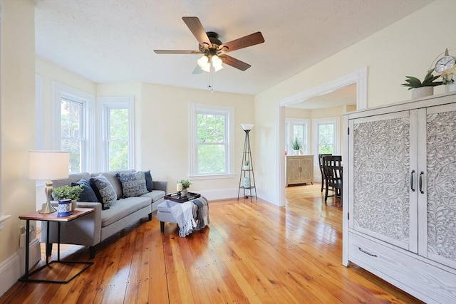 6 Minerva St, Swampscott, MA 01907 - living room with light wood-type flooring, healthy amount of natural light, a ceiling fan, and baseboards
