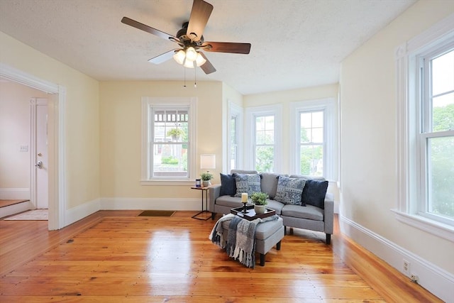 6 Minerva St, Swampscott, MA 01907 - living area featuring plenty of natural light, light wood-style floors, and a textured ceiling