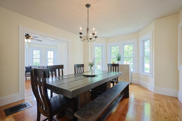 6 Minerva St, Swampscott, MA 01907 - dining space with baseboards, light wood finished floors, and a chandelier