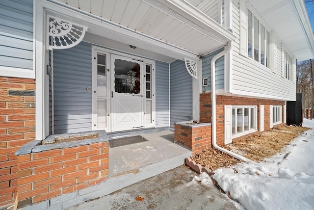 view of exterior entry with brick siding