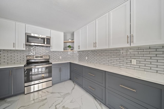 kitchen with marble finish floor, gray cabinets, and stainless steel appliances