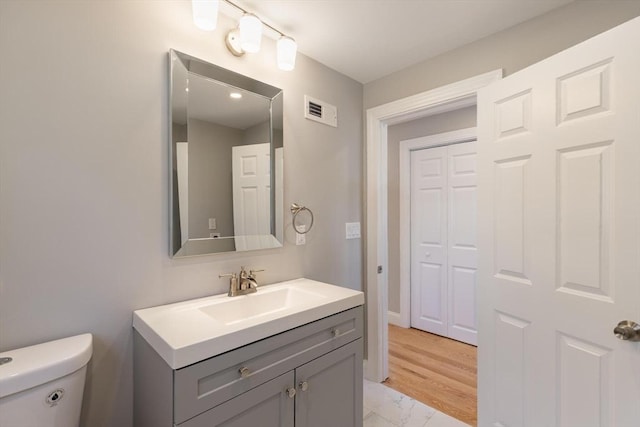 bathroom with toilet and vanity