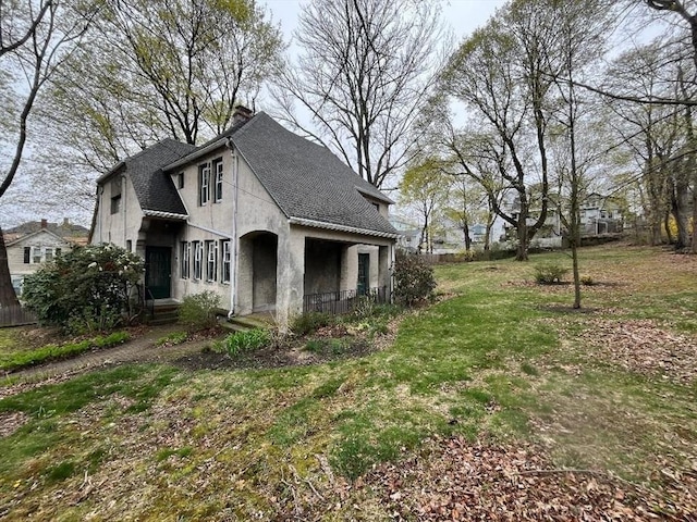 909 High St, Fall River, MA 02720 - view of side of property with stucco siding and a shingled roof