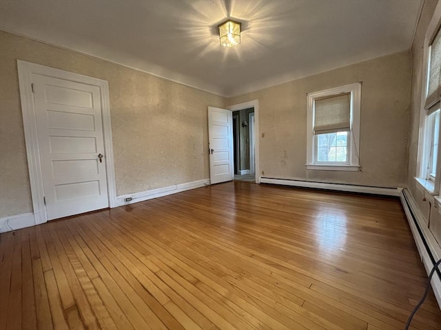 909 High St, Fall River, MA 02720 - empty room with hardwood / wood-style flooring, baseboard heating, and baseboards