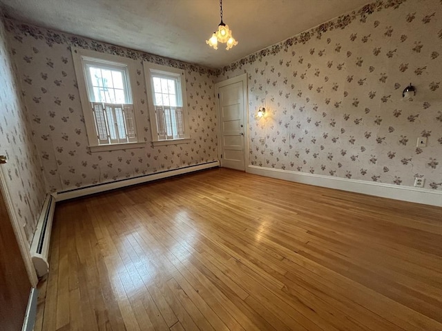 909 High St, Fall River, MA 02720 - unfurnished room featuring light wood-style flooring, wallpapered walls, baseboards, a baseboard radiator, and a chandelier
