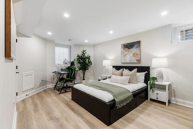 bedroom featuring light wood finished floors, baseboards, and recessed lighting