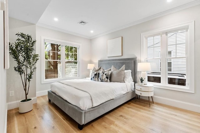 bedroom featuring wood finished floors, baseboards, crown molding, and recessed lighting
