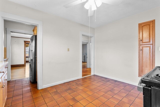 interior space featuring ceiling fan and tile patterned flooring