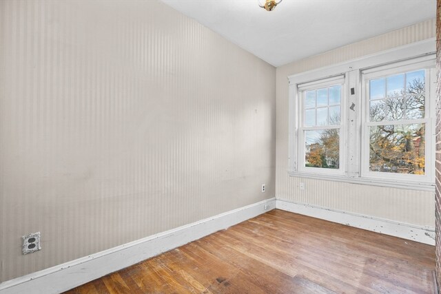 unfurnished room with wood-type flooring