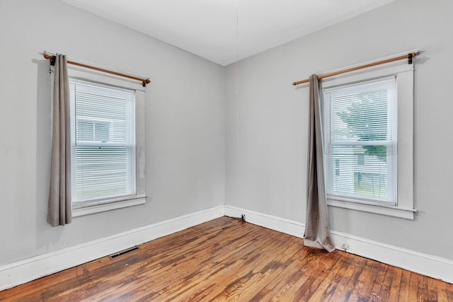 spare room featuring wood-type flooring