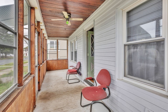 sunroom / solarium with ceiling fan and wooden ceiling