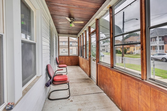 unfurnished sunroom with ceiling fan and wooden ceiling