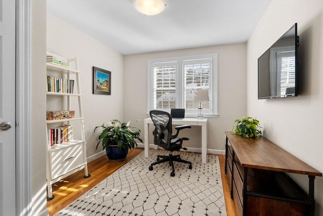 home office with hardwood / wood-style floors