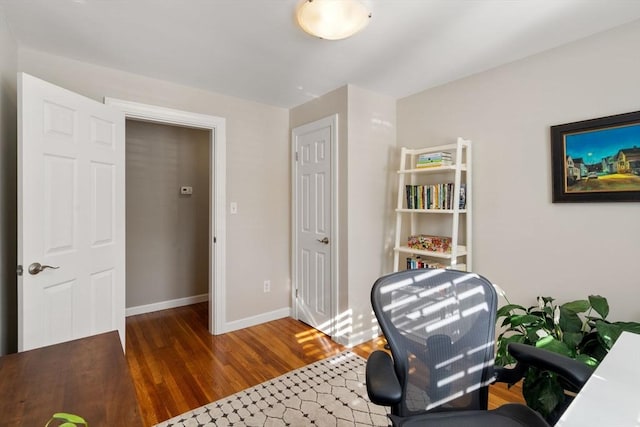 office with dark hardwood / wood-style flooring